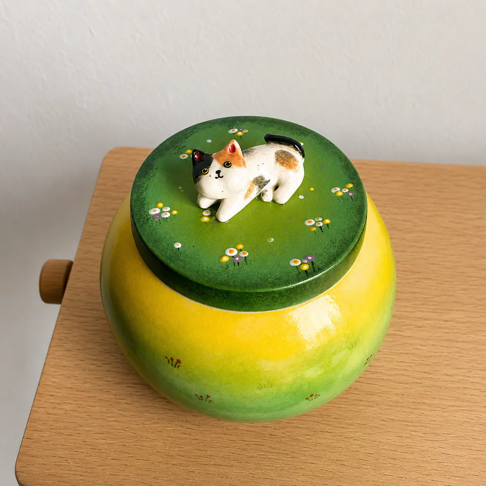 Yellow and green personalized ceramic urn with a hand-modeled cat